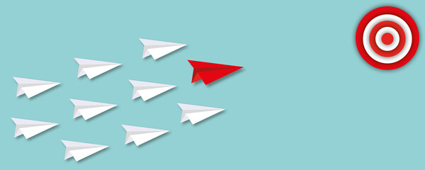 White paper planes follow red paper plane hitting in the target on pastel green background, concept of following the leader straight to the goal, paper cut design style.