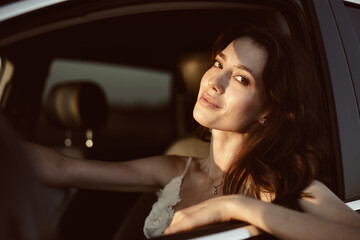 Fototapeta na wymiar Beautiful smiling woman driving her car in the morning