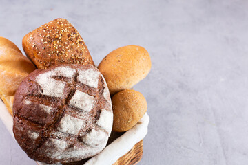 Different kinds of fresh homemade bread in a basket.