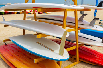 Surfboards stacked on the rack on a beach