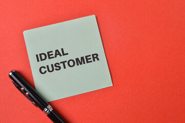 Paper note written with phrase IDEAL CUSTOMER