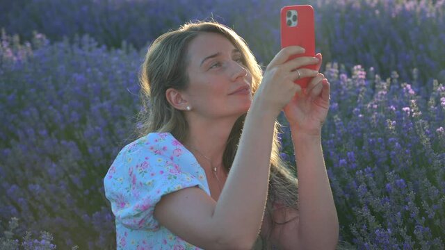 Woman taking pictures in lavender field