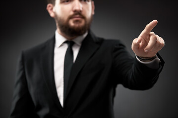 Businessman gesturing with finger forward