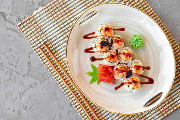 Japanese sushi with sesame seeds and cream icing on gray background