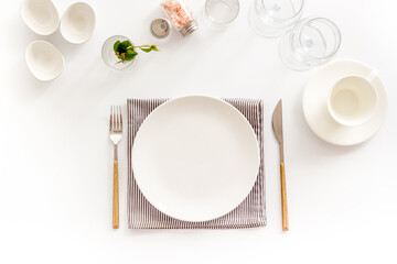 Crockery set - table setting for dinner with dishes and glasses