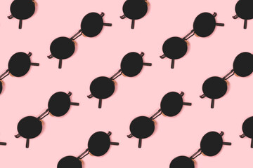 Pattern made of sunglasses on a pink pastel background. Creative summer concept.
