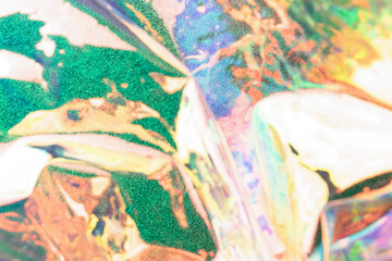 Blurred holographic background. Fluid multicolored texture of wrinkled foil.