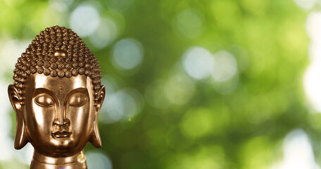 Golden Buddha sculpture outdoors, space for text. Banner design