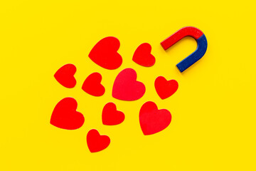 Horseshoe magnet with heart shapes. Love and dating concept