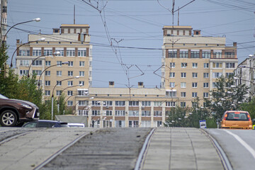 Multi-storey house at the end of the street on a summer day