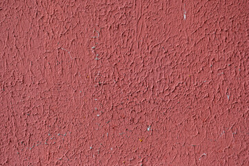 A fragment of an old painted concrete wall in close-up