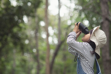 Happy kid looking ahead. Smiling child with the binoculars. Travel and adventure concept. Freedom,...