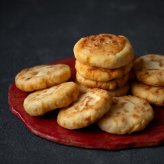 Cottage cheese pancakes. Plate with fresh fried cheese cakes on black background. Sweet breakfast. Side view. Copy space. Soft focus.