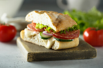 Homemade sandwich with salami and cucumber