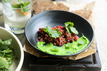 Traditional steak tartare with green hummus