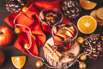 Mulled wine on table with Christmas lights and red napkin, cozy winter still life. Winter lifestyle...