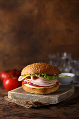 Homemade sandwich or burger with ham and pesto