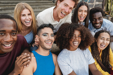 Young diverse people having fun outdoor laughing together - Focus on gay man face - obrazy, fototapety, plakaty
