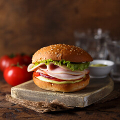 Homemade sandwich or burger with ham and pesto