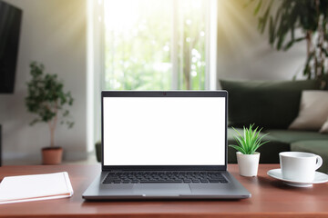 Fototapeta premium Empty laptop screen mock up on table with cup of coffee, note pad and flowerpot