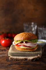 Homemade sandwich or burger with ham and pesto