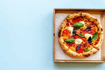 Cut into slices italian pizza with tomatoes cheese and basil