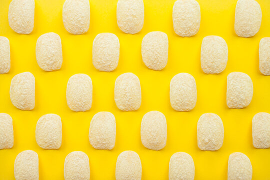 Chips pattern on a bright yellow background. Weight loss and diet concept. High quality photo