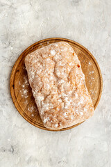 Fresh bread ciabatta loaf top view. Bakery background