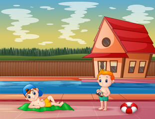 Boy taking pictures in the pool of a resort