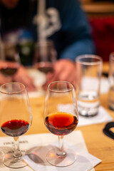 Professional tasting of different fortified dessert ruby, tawny port wines in glasses in porto cellars in Vila Nova de Gaia, Portugal