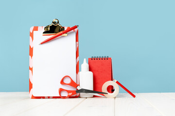 Notice board. office and school red stationery on white desk blue background. Banner for back to...