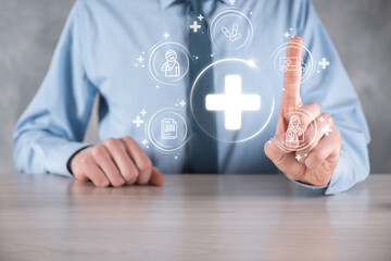 Businessman hold virtual plus medical network connection icons. Covid-19 pandemic develop people awareness and spread attention on their healthcare.Doctor,document,medicine,ambulance,patient icon.