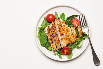 Chopped chicken breast steak with salad. White background with copy space