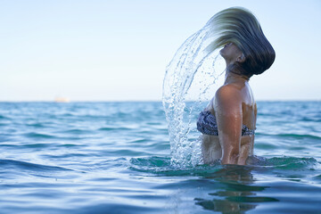 Women flipping hair in the sea