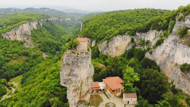 Katskhi pillar. Man's monastery near the village of Katskhi. The orthodox church and the abbot cell on a rocky cliff. Imereti, Georgia.