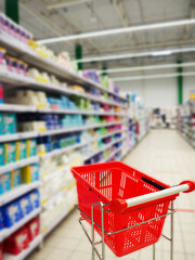 Supermarket shelf blurred trolley. Buy in the supermarket blurring the shelves with products