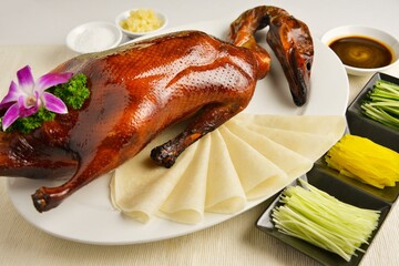 roasted bbq golden Beijing peking whole duck meat in white background asian halal menu