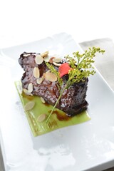 wok fried pork spareribs with almond, sweet and sour coffee sauce in white background asian halal menu