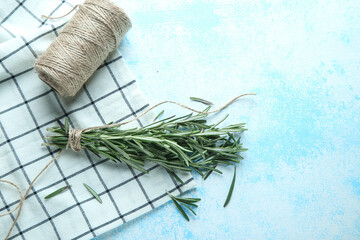 Twigs of fresh rosemary on a blue background with place for text