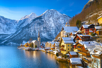 Classic postcard view of famous Hallstatt lakeside town in the Alps with traditional passenger ship...