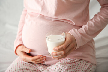 A pregnant girl holds a glass of milk. Healthy Eating