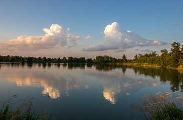 Fototapeta na wymiar Beautiful clouds reflected in the pond during the golden hour
