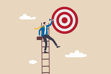 Success ladder, aspiration to achieve target, business goal or work purpose, aim for perfection concept, businessman climb up ladder high into the sky to aiming for perfect bullseye target dartboard. © Nuthawut