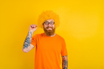 Happy man with beard, yellow wig and glasses