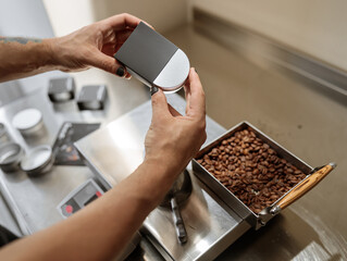Man hands putting metal jar of coffee into black box