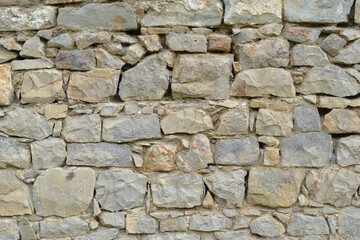 Texture of stone wall with mosaic tiles.