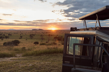 car of tourists at sunset