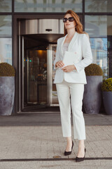 Super busy business woman wear fashion white suit and black heels, style office every day