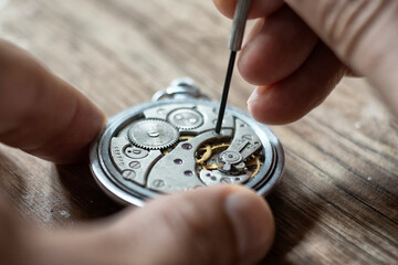 Mechanical watch repair. Watchmaker repairs vintage mechanical watches. Watchmaker's workshop.