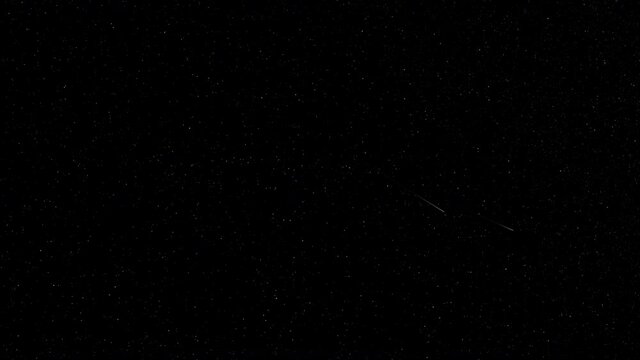 A meteor shower shooting across the starry night sky.